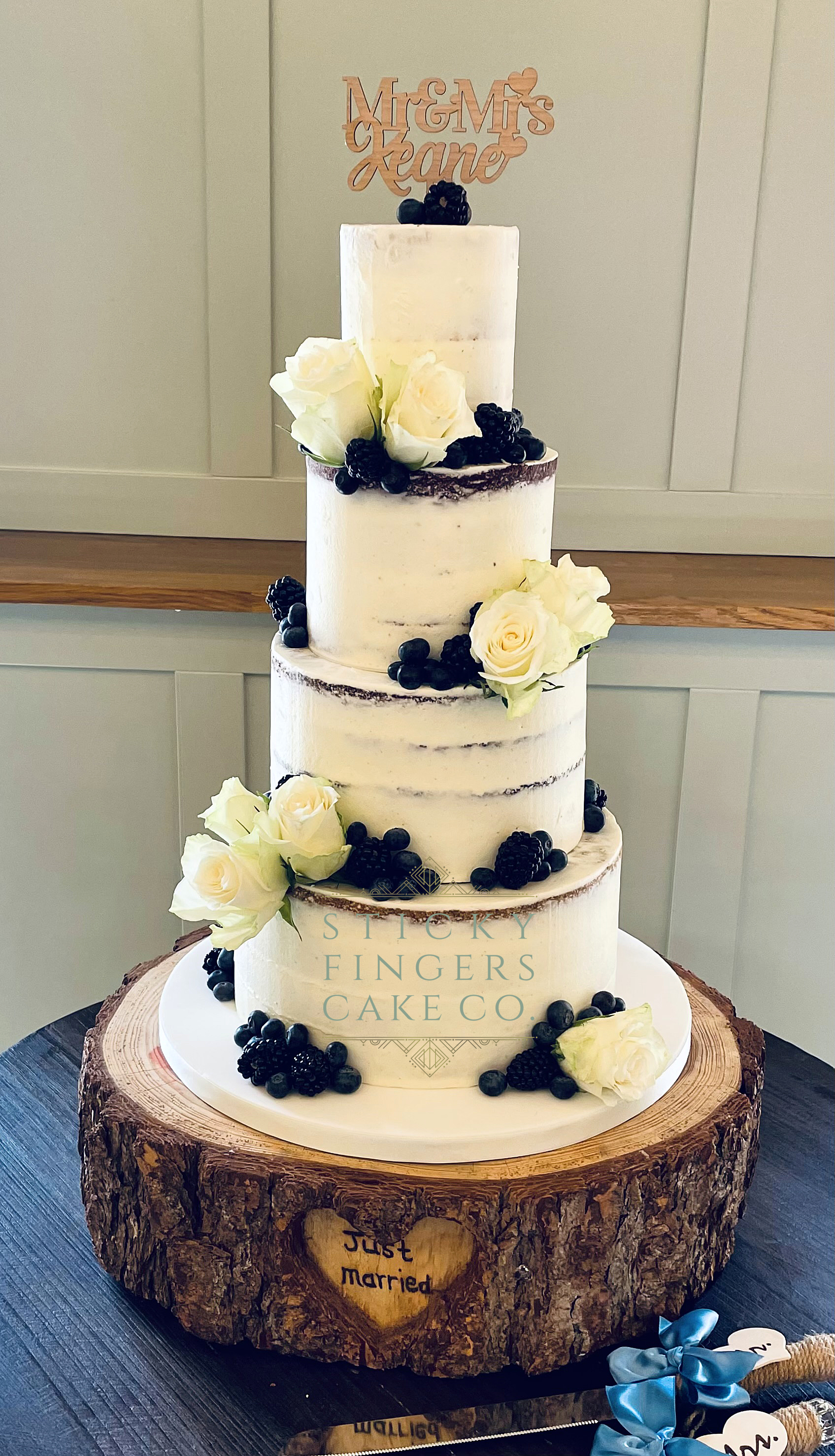 4-tier Semi Naked Wedding Cake displayed at Apton Hall, Rochford