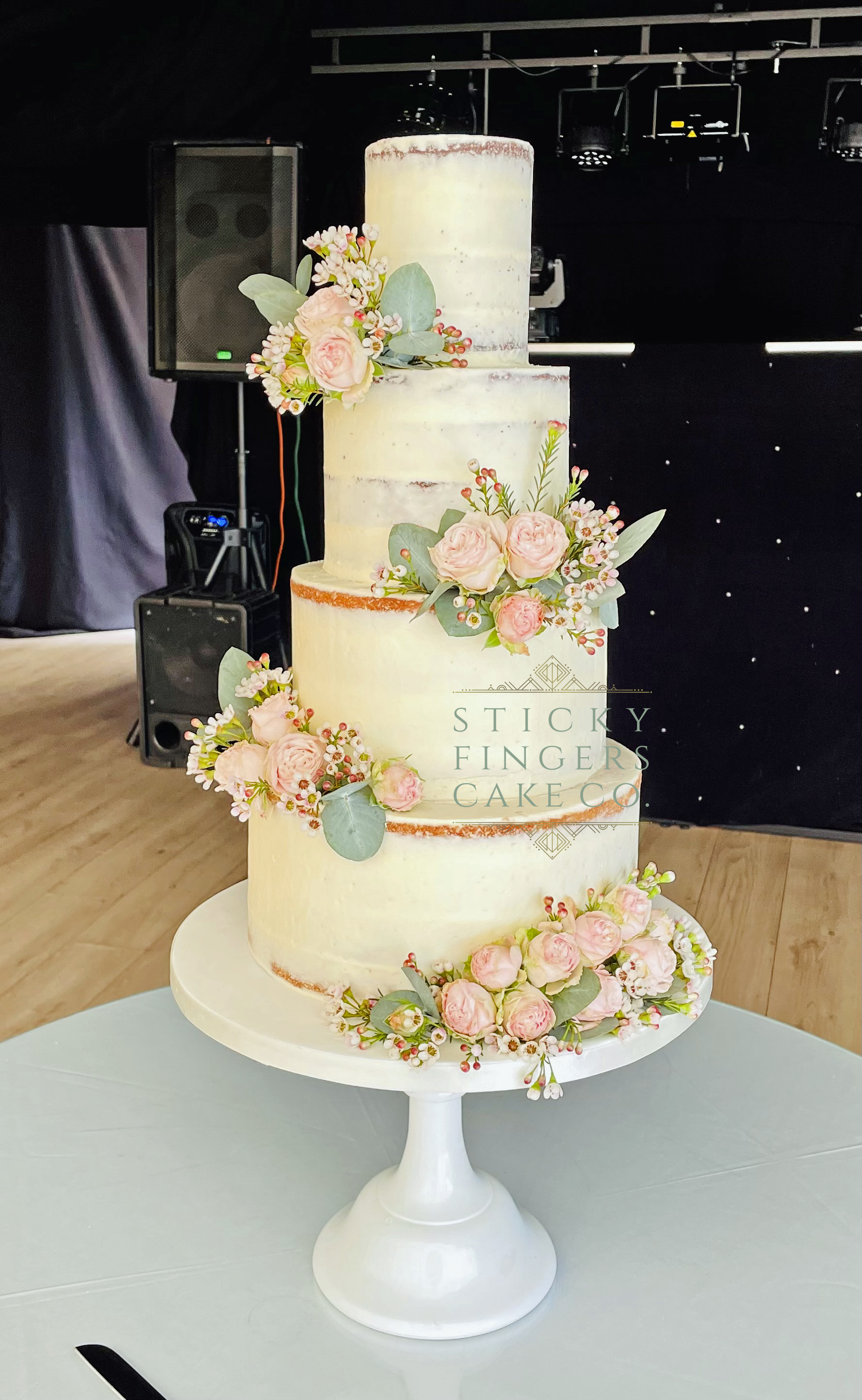 4-tier Semi Naked Wedding Cake displayed at Downham Hall, Billericay